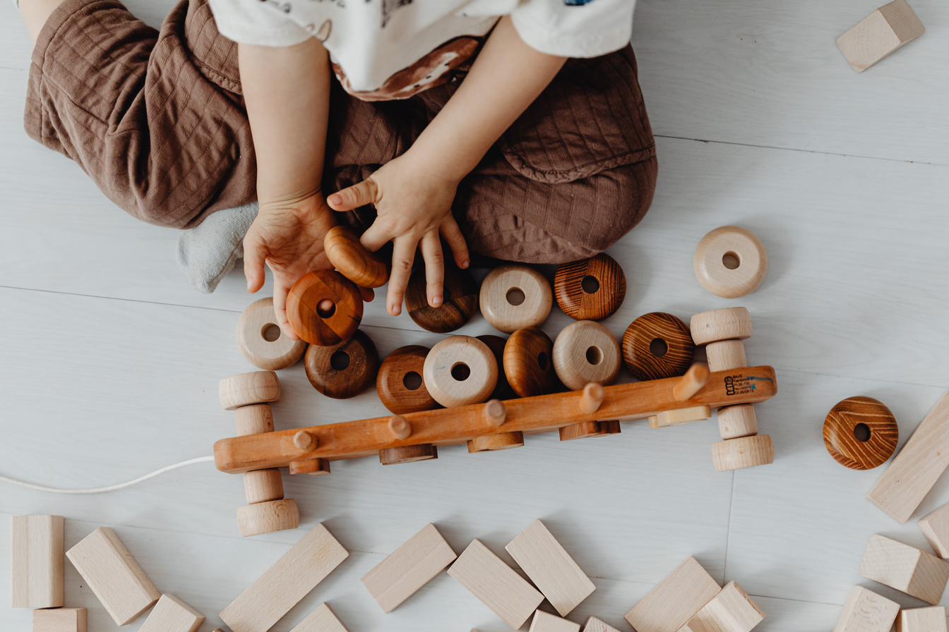 Child Playing with Wooden Toys